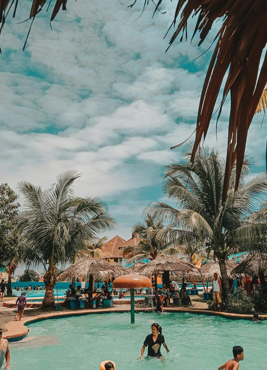 Relaxing resort with palm trees and pool fun on a sunny day.